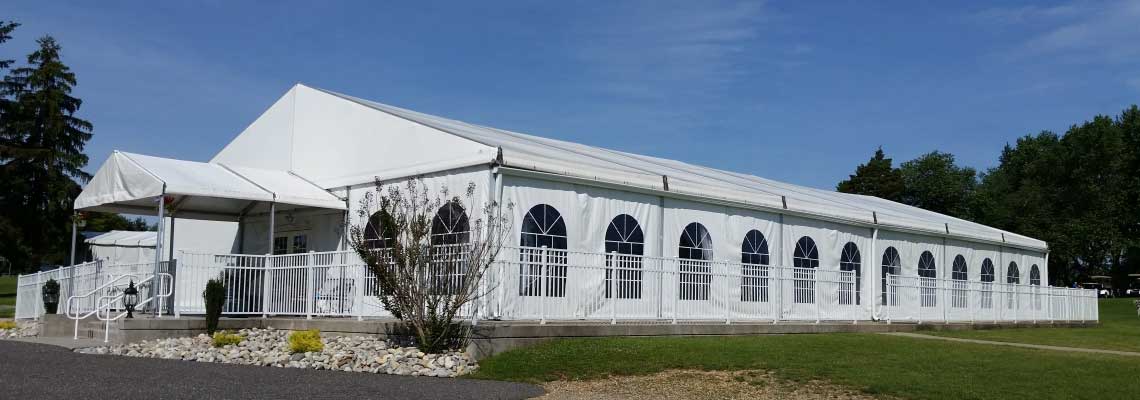 Showing the Sunset Pavilion white tent from outside.