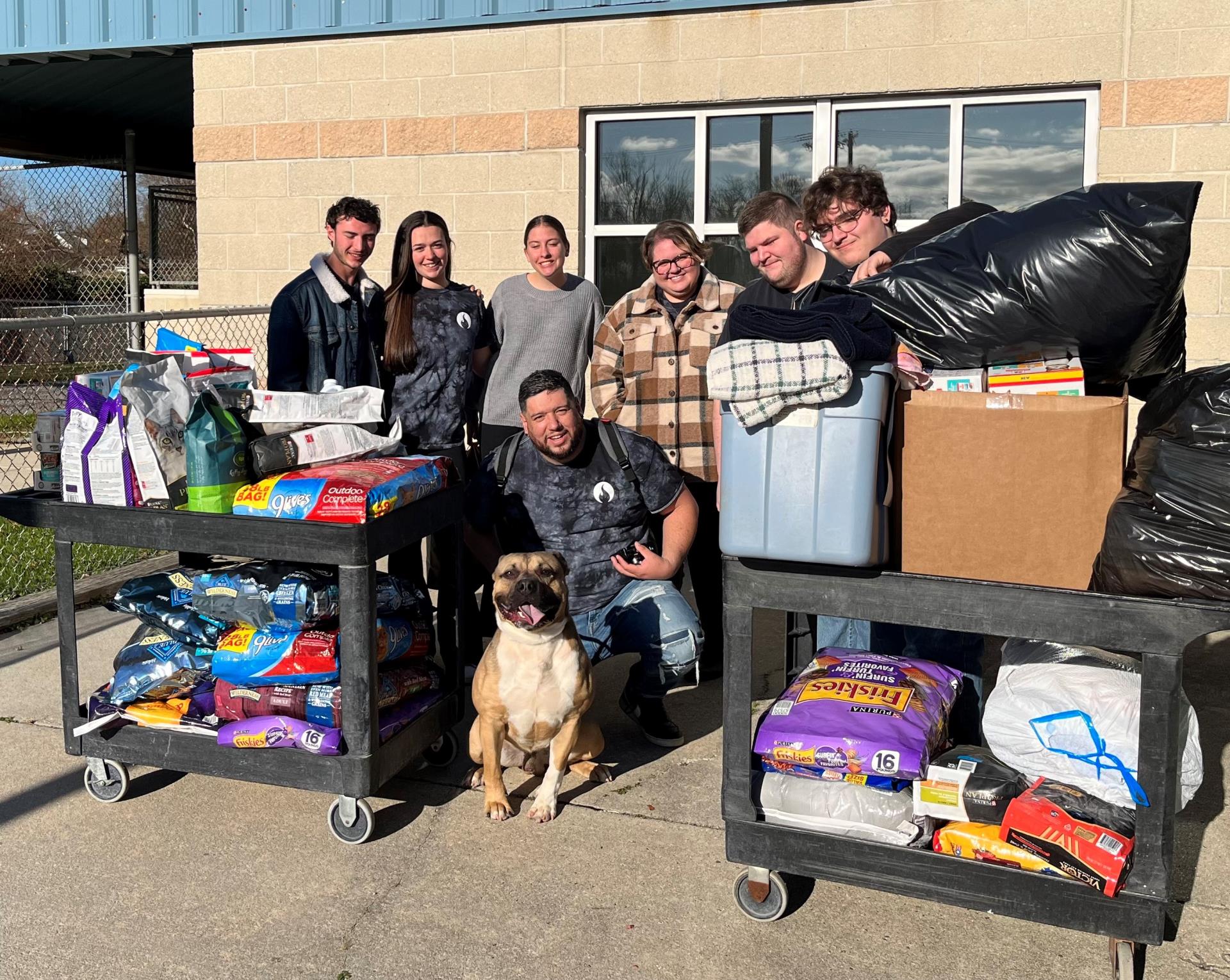 Two full carts of donations and members of the First United Methodist Church Donations 11-25-23