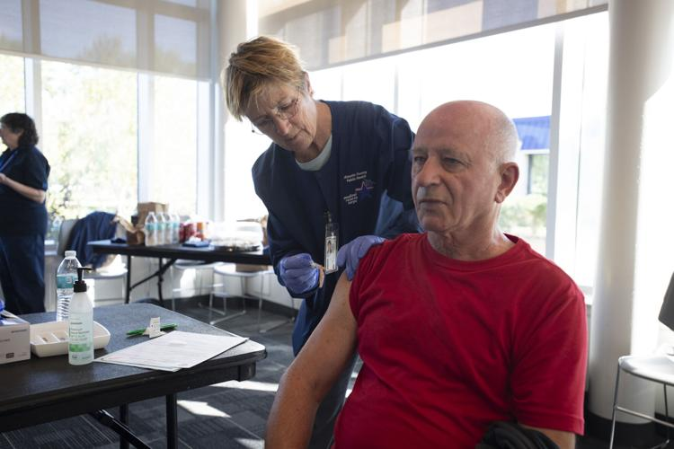 MRC volunteer administering a vaccination