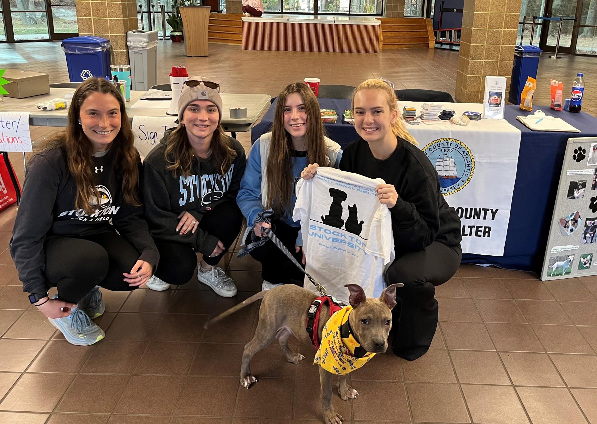 Stockton students and Tiny, the puppy